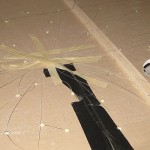 taping-fiber-optics Since we didn't have access to the ceiling from above, we threaded fiber optic strings through holes we'd drilled in sheetrock, taped and glued them into place, and then hung the pieces in sections